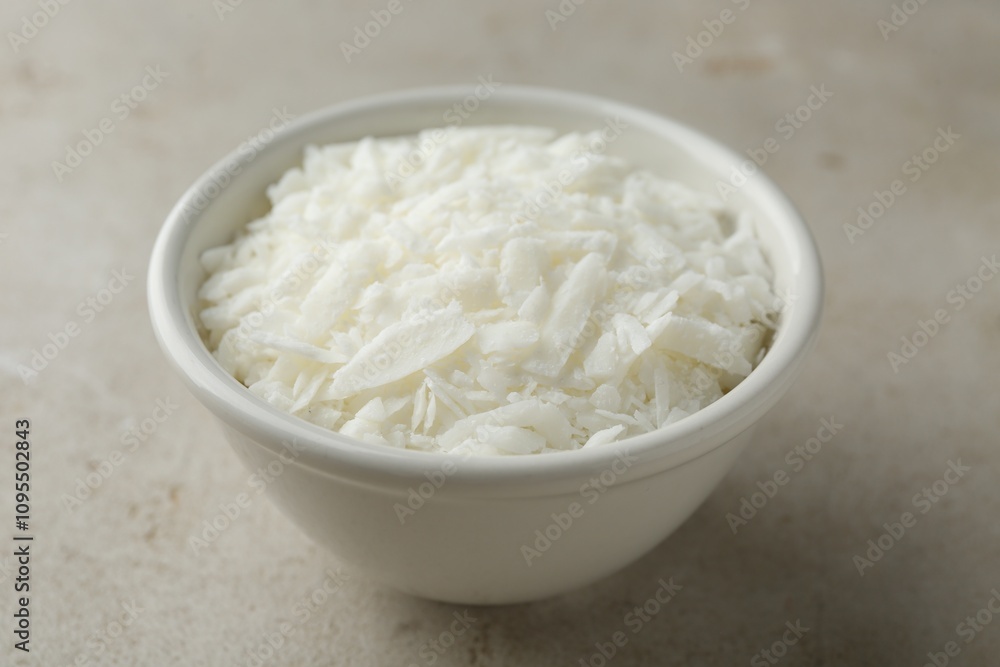Soy wax in bowl on light grey table, closeup Soy wax in bowl on light grey table, closeup