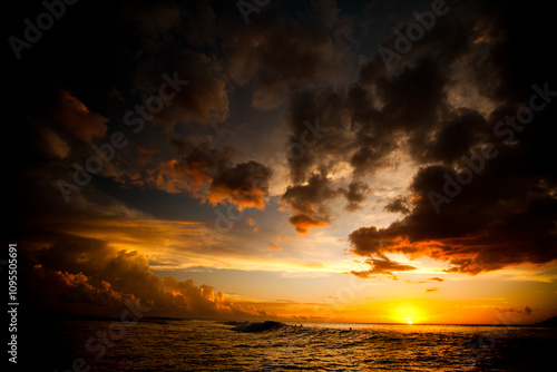Majestic sunset reflecting off parting storm clouds and beautiful ocean 