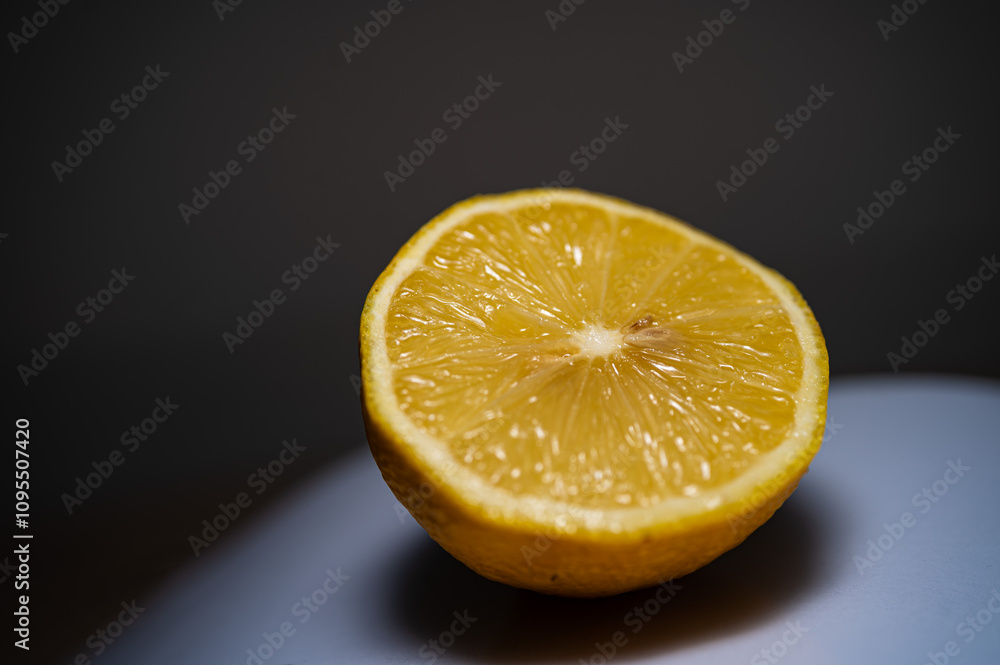 Half sliced lemon in the light Half sliced lemon in the light