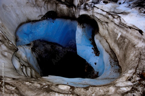 Ice and stone leading into darkness below photo