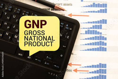 Paper with GNP Gross National Product on a table with charts photo