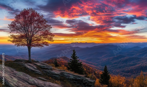 Breathtaking sunset over mountains with vibrant colors, lone tree on rocky outcrop, autumn foliage, dramatic sky