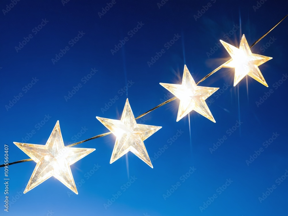 Decorative string lights with star shapes illuminate a tranquil evening sky in a serene setting
