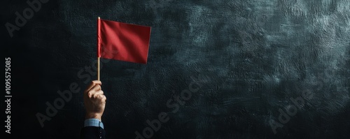 Business professional raising red flag in dark setting alerting risks and issues corporate environment serious tone photo