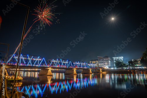  fireworks show at iron bridge across ping river where decorate with a lot of colorful light lanterns is highlight of yee peng loy krathong festival chiangmai thailand November 2024