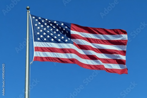 American flag waves against clear blue sky in patriotic display