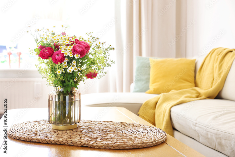 Naklejka premium Beautiful ranunculus flowers and chamomiles in vase on table indoors. Space for text