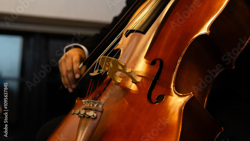 Close up A hand of Musician playing cello at orchestra classic concert 