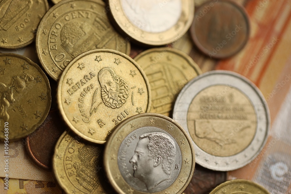 Many cent coins of euro currency lies on many fifty euro bills banknotes Many cent coins of euro currency lies on many fifty euro bills banknotes