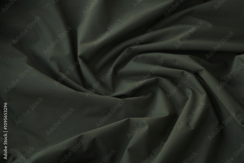 Obraz premium Texture of Dark green military uniform textile cloth with folds