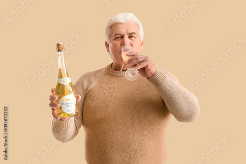 Senior man with glass and b...