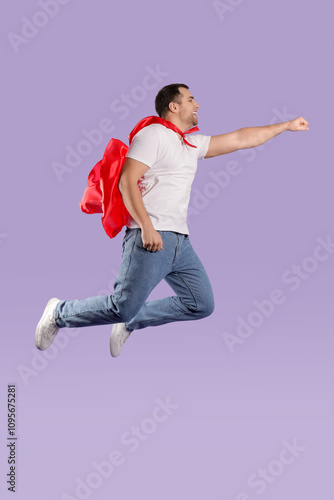 Young man in superhero cloa...