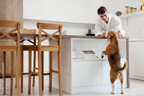 Young man in bathrobe with ...