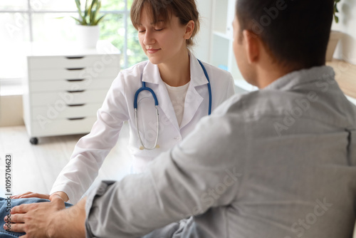 Female doctor examining man...