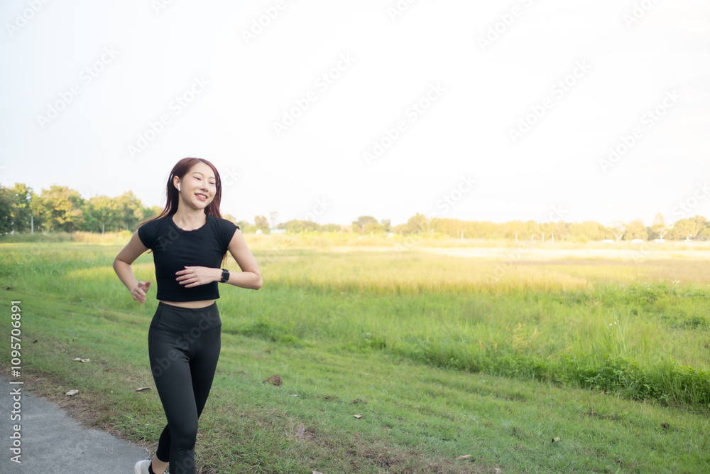 A woman is running in a field with a green grass A woman is running in a field with a green grass