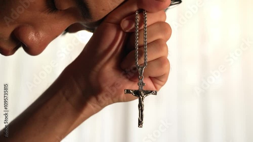 Sense of devotion and spiritual fulfill with christian catholic follower immerse in faith. Slow motion christian holding holy cross while praying to worship the god. Burgeoning