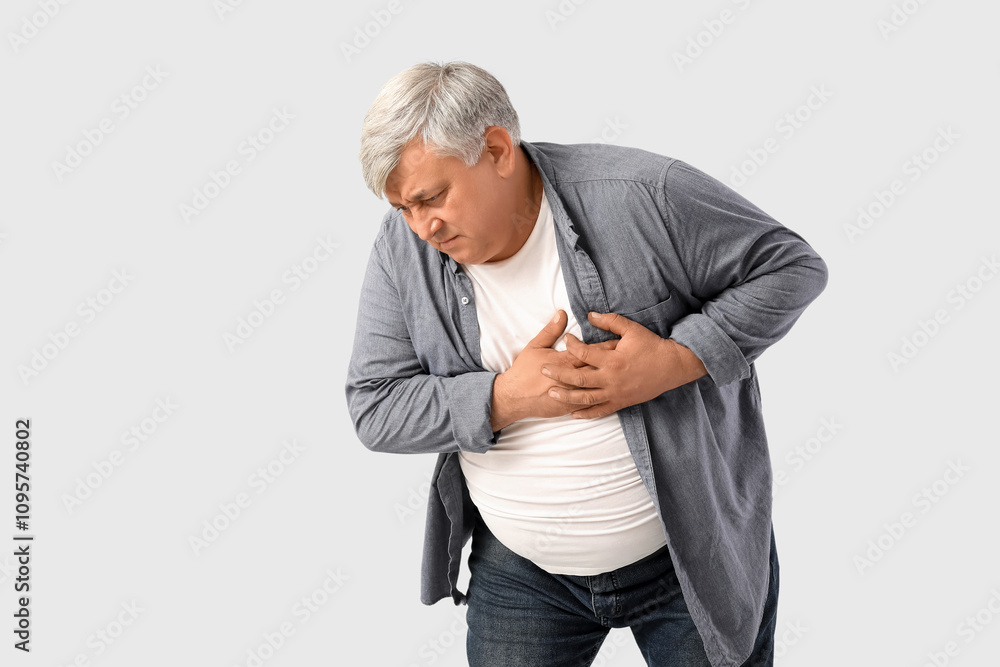 Senior man having heart attack on light background Senior man having heart attack on light background