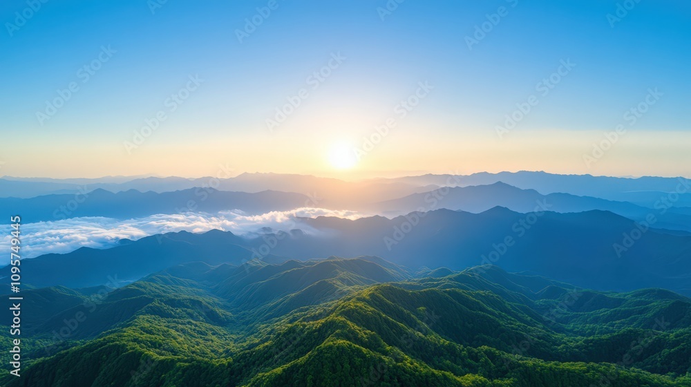 Fototapeta premium The sun is setting over the mountains, casting a warm glow over the landscape