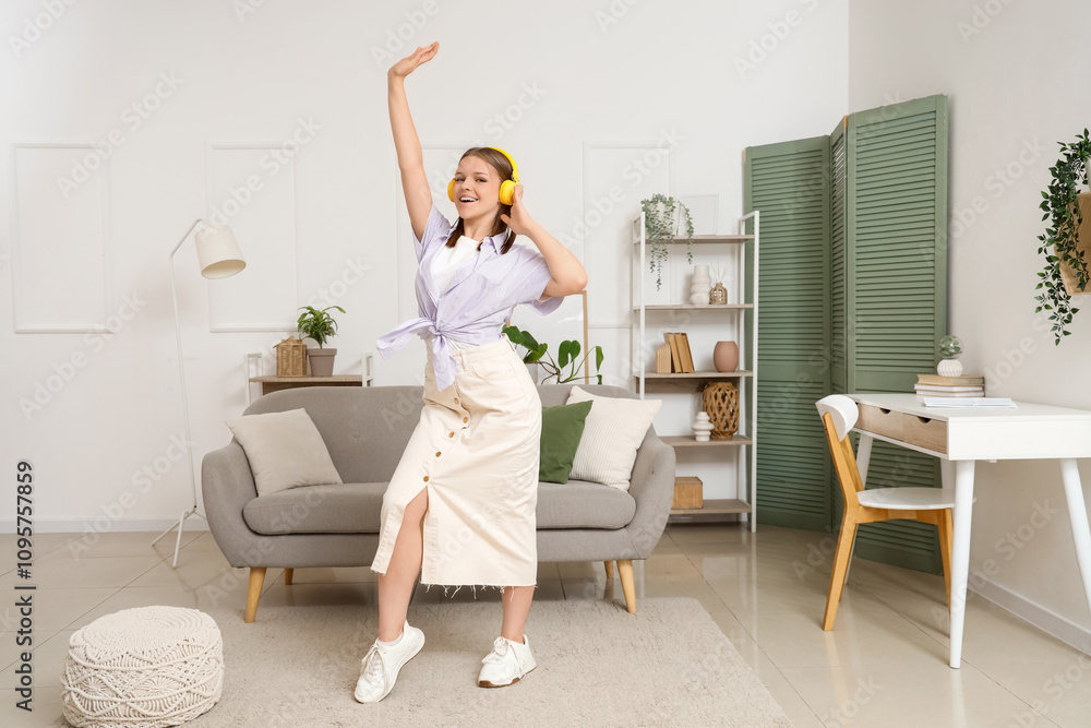 Young woman in headphones dancing at home Young woman in headphones dancing at home