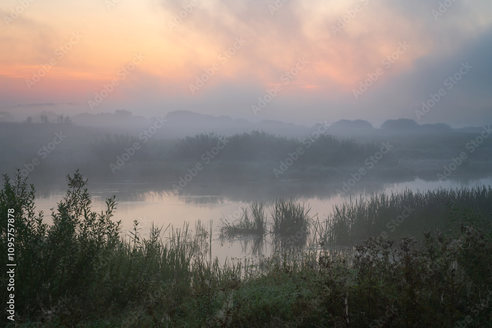 The valley of the Sorot River near the Mikhailovskoye Estate of the Pushkin Museum-Reserve at dawn on a foggy summer morning, Pushkinskiye Gory, Pskov Oblast, Russia The valley of the Sorot River near the Mikhailovskoye Estate of the Pushkin Museum-Reserve at dawn on a foggy summer morning, Pushkinskiye Gory, Pskov Oblast, Russia