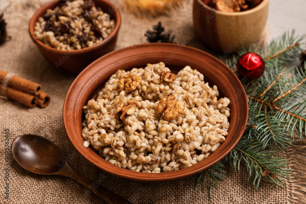 Bowls of traditional Ukrainian Kutya dish with cinnamon and Christmas tree branch on grey background Bowls of traditional Ukrainian Kutya dish with cinnamon and Christmas tree branch on grey background