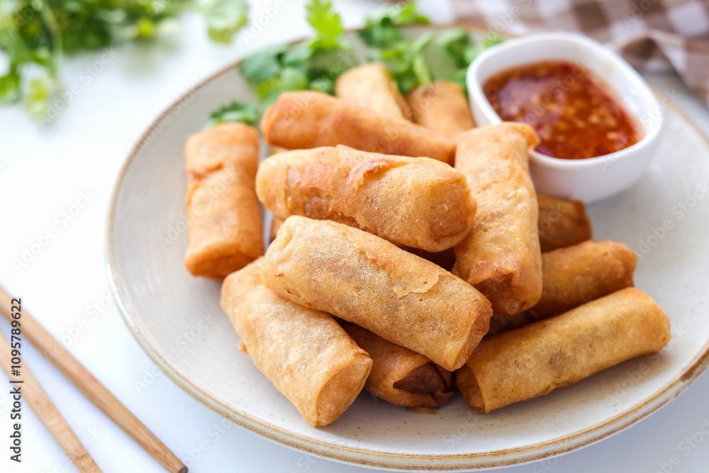 Deep fried vegetable spring rolls or egg rolls and sauce , Thai called popia on white background, vegetarian food Deep fried vegetable spring rolls or egg rolls and sauce , Thai called popia on white background, vegetarian food