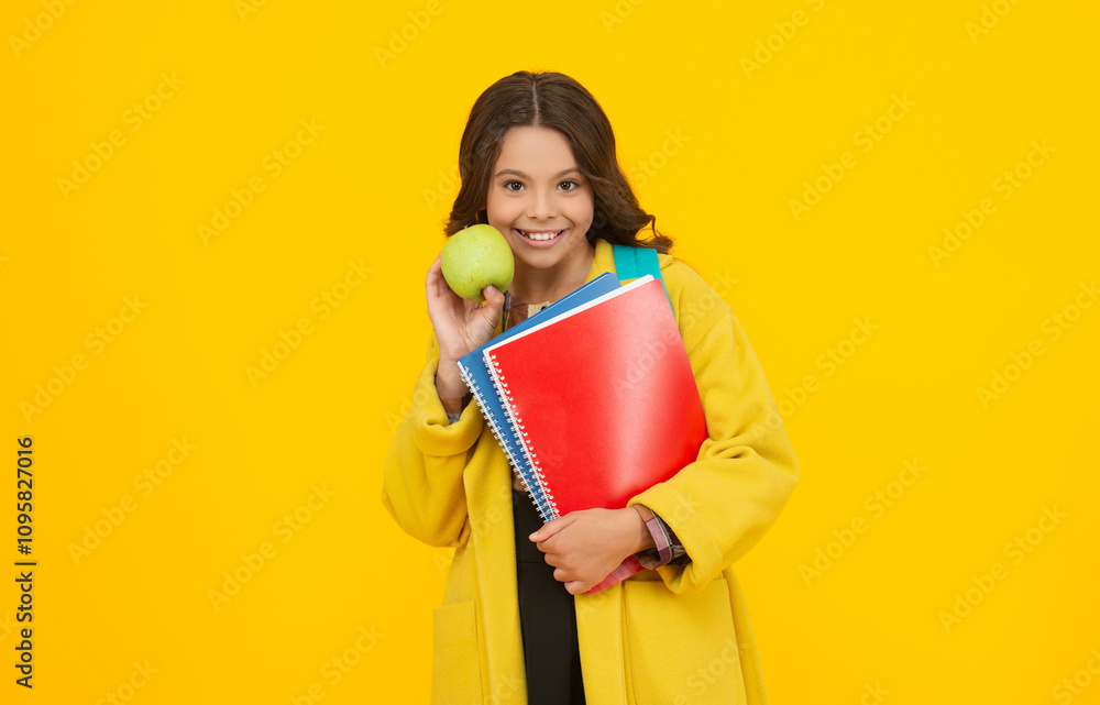 School education of girl with apple. Knowledge and education. Girl in autumn hold school homework. Back to school. Teen girl with homework in autumn. Student has homework isolated on yellow School education of girl with apple. Knowledge and education. Girl in autumn hold school homework. Back to school. Teen girl with homework in autumn. Student has homework isolated on yellow