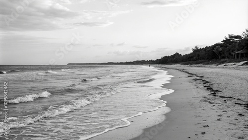 A serene black and white beach scene with calm waves and sandy shores, calm waters, soothing colors, black and white photography, sand dunes