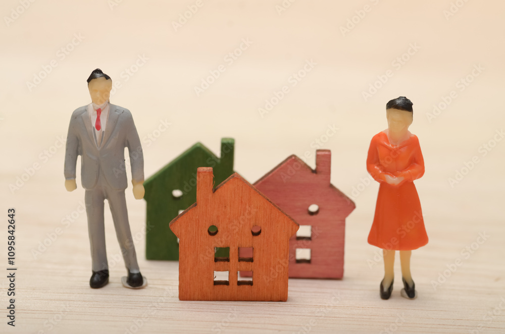 This image could symbolize a couple husband and wife considering buying a home or a family who has recently purchased a house. This image could symbolize a couple husband and wife considering buying a home or a family who has recently purchased a house.