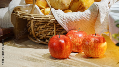 Red apples on table and bread in basket, still life food photography photo