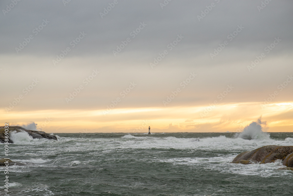 a lighthouse stands in the storm. Wild sea in a long exposure. Sunset on a coast with many rocks in the North Sea. Seascape in Sweden, Scandinavia, Europe a lighthouse stands in the storm. Wild sea in a long exposure. Sunset on a coast with many rocks in the North Sea. Seascape in Sweden, Scandinavia, Europe