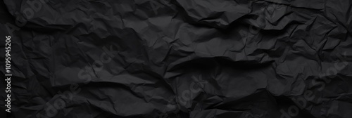 Textural Black Crumpled Paper Background with Detailed Surface Variations for Use in Graphic Design and Artistic Projects