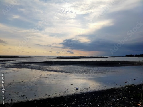 beach atmosphere in the afternoon with big waves and beautiful black sand