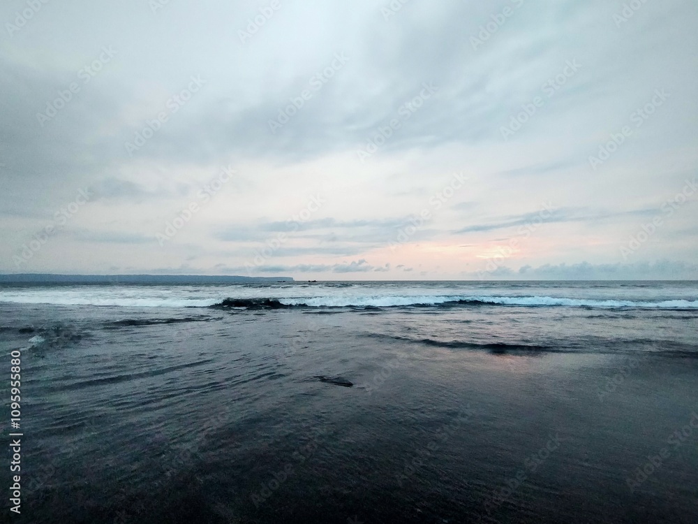 beach atmosphere in the afternoon with big waves and beautiful black sand beach atmosphere in the afternoon with big waves and beautiful black sand