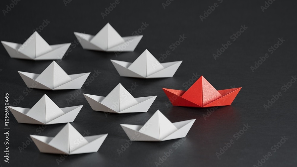 Different business concept.new ideas. paper art style.Leadership concept with red paper ship leading among white boats.3D rendering on black background. Different business concept.new ideas. paper art style.Leadership concept with red paper ship leading among white boats.3D rendering on black background.