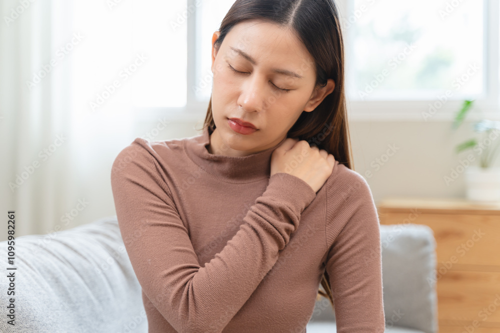 muscles stiff problem, suffer young woman, girl face painful, hand holding neck ache from work hand holding massaging rubbing shoulder hurt, sore sitting on couch at home muscles stiff problem, suffer young woman, girl face painful, hand holding neck ache from work hand holding massaging rubbing shoulder hurt, sore sitting on couch at home