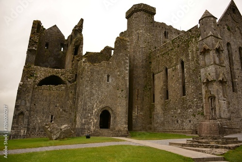  Ancient stone abbey ruins with a graveyard under cloudy skies. Republic of Ireland