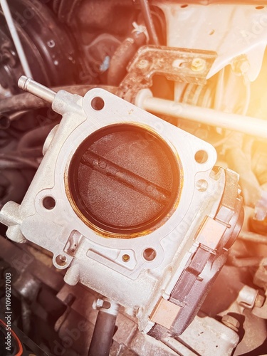 Carbonized electronic throttle body in car engine intake. Needs to be cleaned by carb or brake cleaner slolution and mild brush. photo