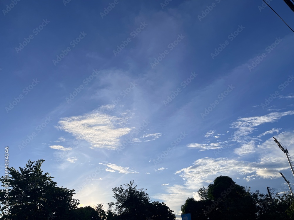 This image captures a blue sky with clouds, showcasing the vastness and beauty of nature. The vibrant blue color of the sky evokes a sense of calm and relaxation, highlighting the serene and This image captures a blue sky with clouds, showcasing the vastness and beauty of nature. The vibrant blue color of the sky evokes a sense of calm and relaxation, highlighting the serene and