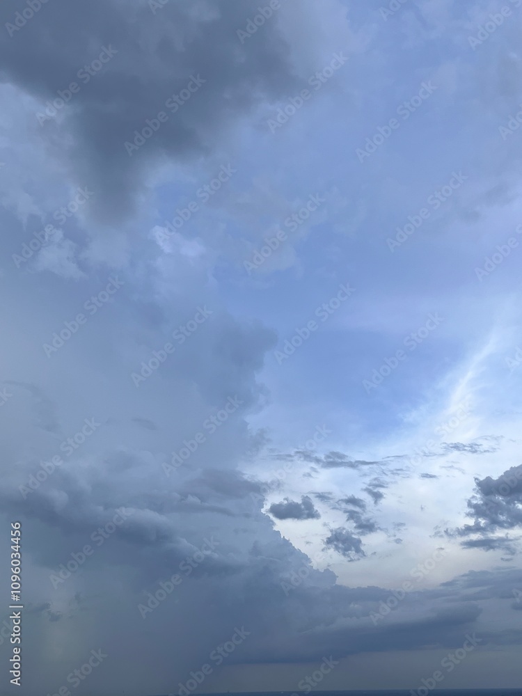 This image captures a blue sky with clouds, showcasing the vastness and beauty of nature. The vibrant blue color of the sky evokes a sense of calm and relaxation, highlighting the serene and This image captures a blue sky with clouds, showcasing the vastness and beauty of nature. The vibrant blue color of the sky evokes a sense of calm and relaxation, highlighting the serene and