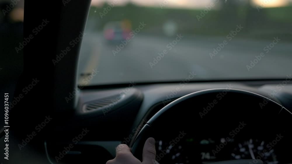 View from drivers perspective with hand on steering wheel, showing speedometer and blurred highway ahead, capturing mood of an evening drive blurred highway ahead drivers perspective highway View from drivers perspective with hand on steering wheel, showing speedometer and blurred highway ahead, capturing mood of an evening drive blurred highway ahead drivers perspective highway