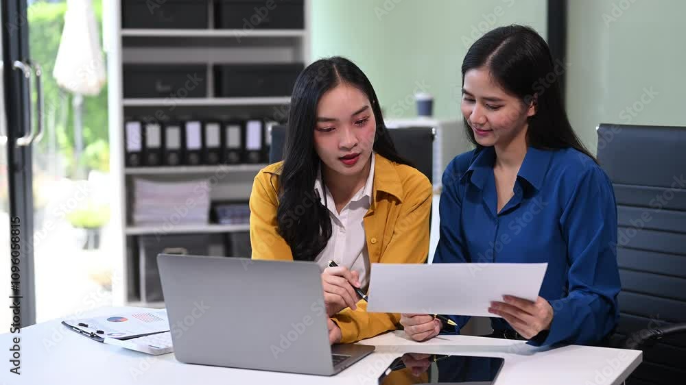 emale discussing new project with male colleague. Young woman talking in office.