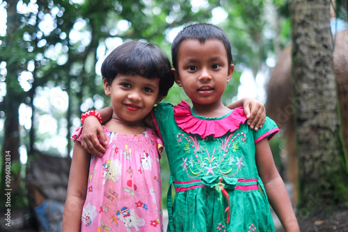 Schilderij op canvas South asian little sisters standing together in outdoor wearing colourful dresse
