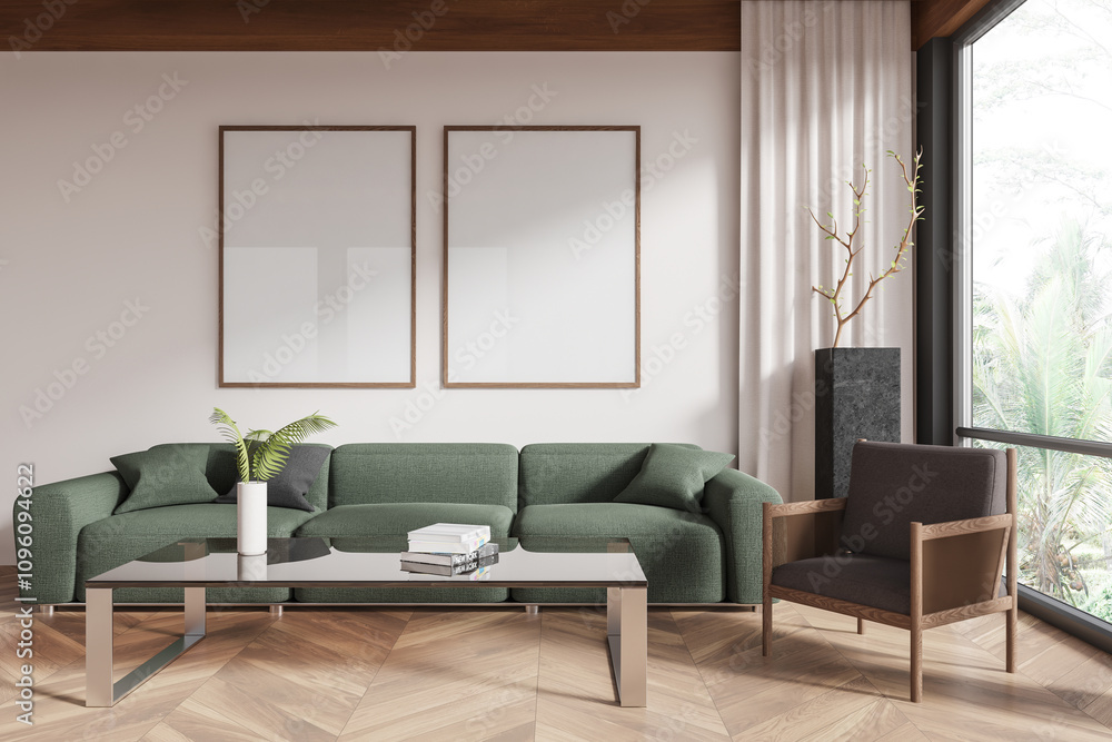 Fototapeta premium Two empty framed posters on a modern living room wall with green sofa and wooden flooring. 3D Rendering
