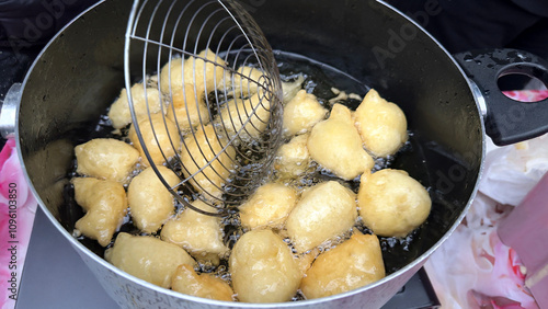 Pettole or pittule. Very soft leavened dough balls fried in boiling oil, typical of the Christmas period in southern Italy and of the day of Saint Cecilia photo