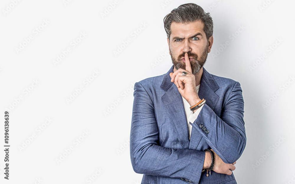 © Yevhen - Handsome man asking for silence, quiet, gesturing with finger in front of mouth, saying shh or keeping a secret. Secret and silence. Copy space