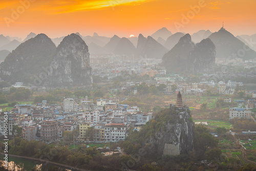 Sunset over the Guilin city surrounded by picturesque limestone mountains. Guilin, China, Copy space for text, aerial photo