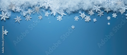 Winter wonderland snowflakes framing a blue background with ample copy space for seasonal promotions or holiday greetings