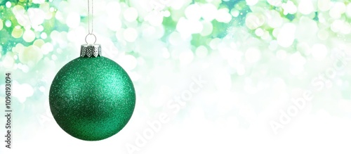 Shimmering green ornament silhouette on white background with bokeh effect ideal for festive designs and text overlay in flat vertical layout photo