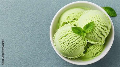 Creamy green mint ice cream in a white bowl. photo